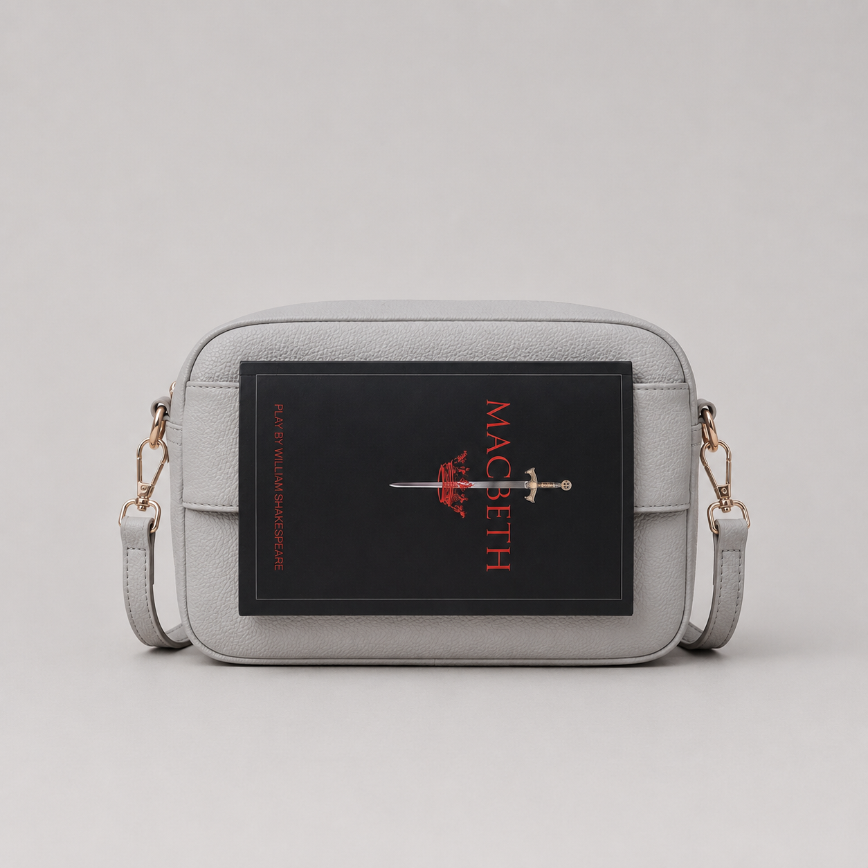 The Daily Stone bookmark-inspired crossbody bag holding a book
