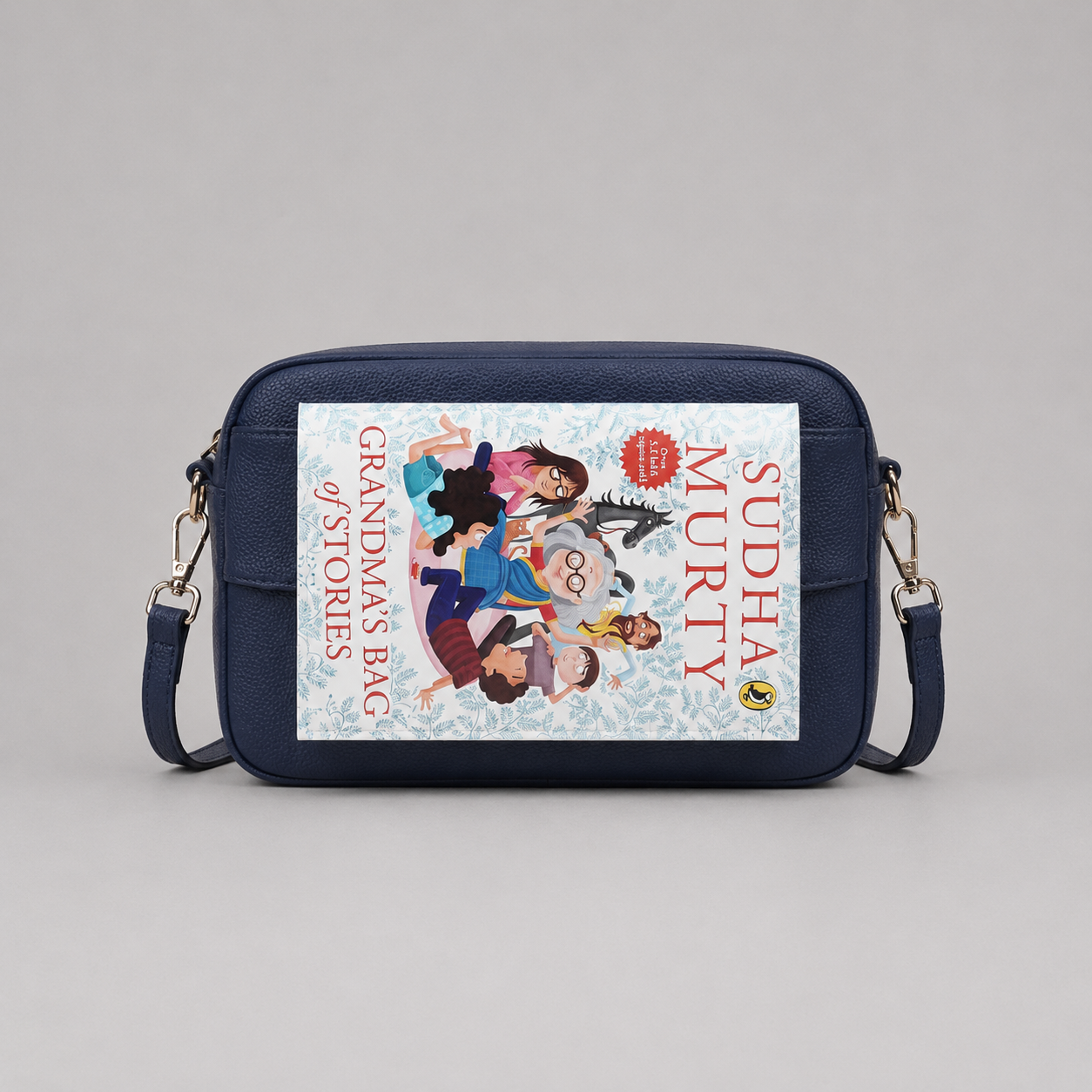 The Daily Navy bookmark-inspired crossbody bag holding a book