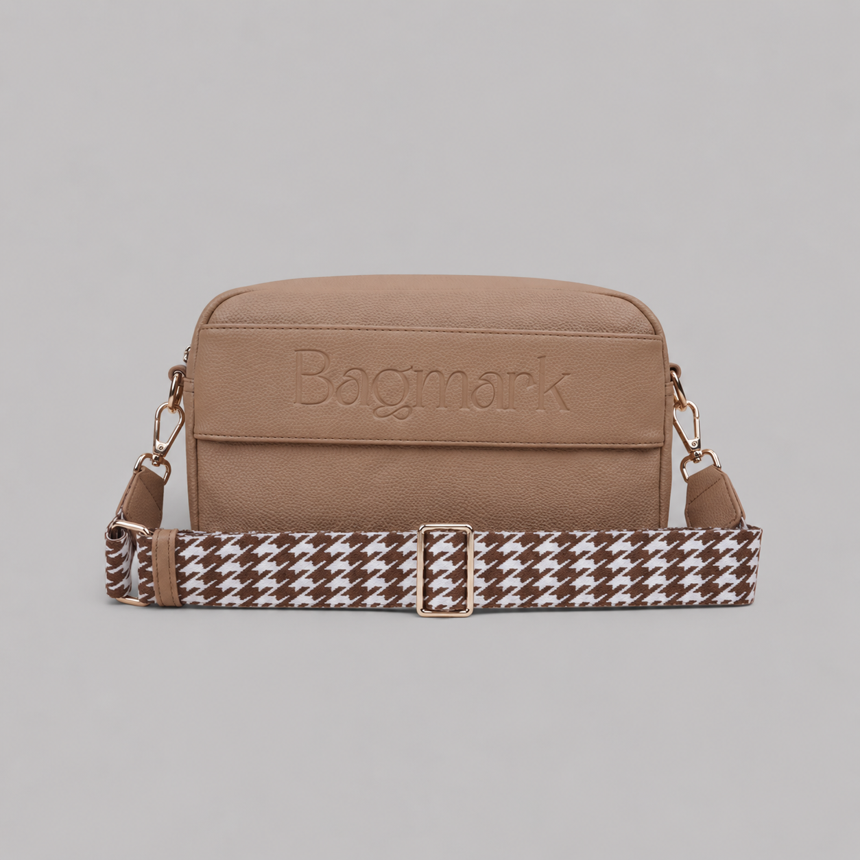 The Daily in Camel bookmark crossbody bag with a patterned webbing strap