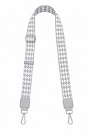 Houndstooth patterned strap with silver hardware on a white background